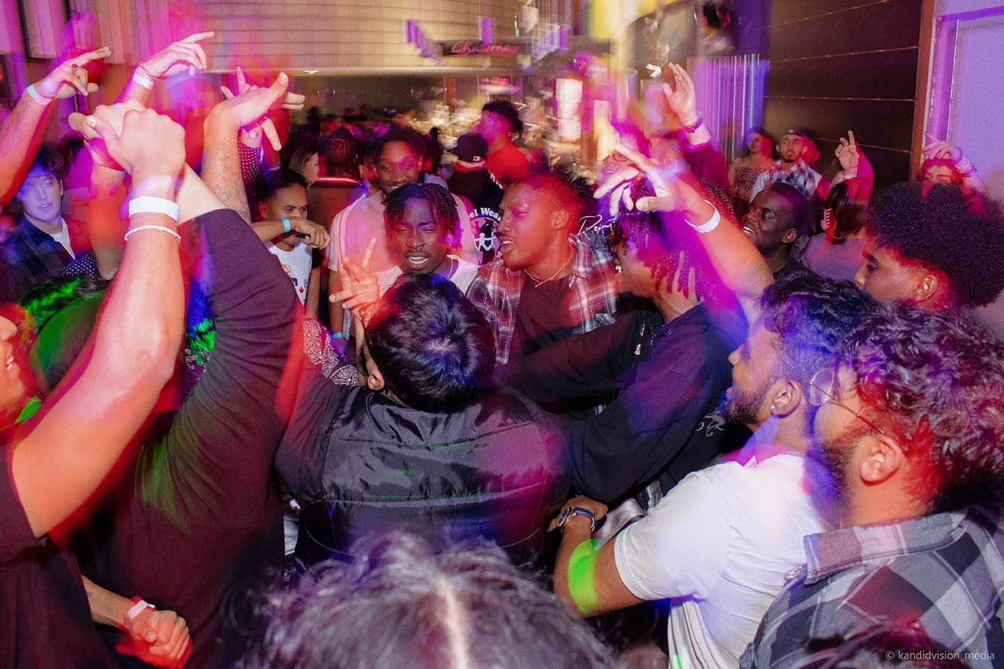 Students dancing and laughing in a brightly lit room