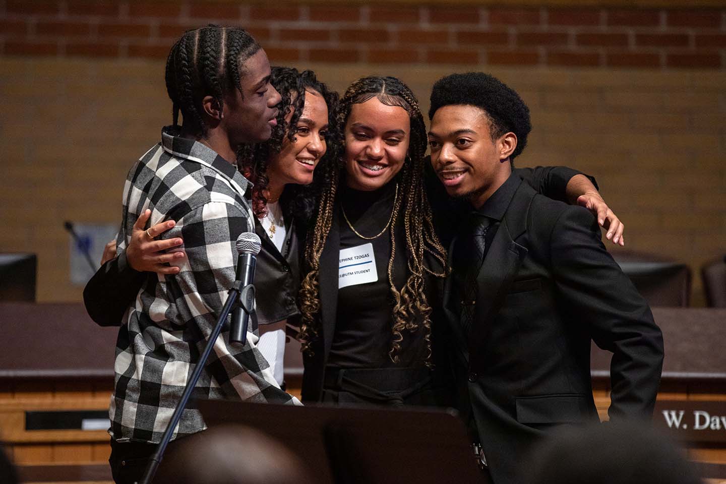 Four studnets hug during the SEE @ UTM celebration and graduation at the H.J.A. Brown Education Centre in Mississauga